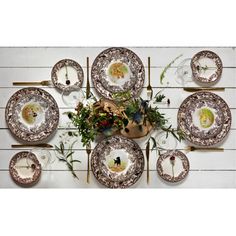 a table with plates and flowers on it