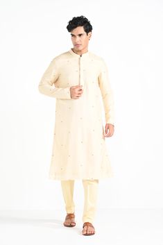 Rajasthani floral Hand embroidered nehru kurta set made in cream bamberg raw silk. Paired with cream slim fit Pant Pajama. Color of the actual garment may vary due to lighting conditions during the shoot.

Size Chart For Men





	
	
					Men's Size Chart
		

		
		
						
				Size Chart For Men
				Custom Size Measurement Guide
			
			
				
				
				Custom Size Measurement Guide
1. Take your measurements at ease…don’t hold your breath!
2. Be a little generous with the measurements. It’s always e Off White Kurta With Gota Work For Eid, Unstitched Cream Kurta With Gota Work, Unstitched Off White Kurta For Festive Occasions, Beige Raw Silk Kurta With Naqshi, Festive Cream Raw Silk Kurta, Cream Kurta With Zari Work In Raw Silk, Cream Raw Silk Kurta With Zari Work, Cream Churidar With Naqshi On Straight Kurta, Off White Raw Silk Kurta With Naqshi