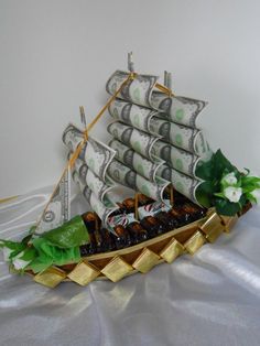 a model boat with money in it on a table