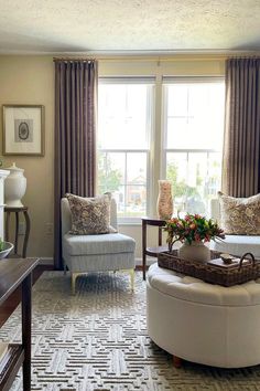 a living room filled with furniture and a large window