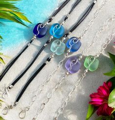 Gorgeous Sea Burst Beads ~ in the multiple shades of colors!....   Cultured Sea glass jewelry. The same soft finish as found in natural sea glass.  These bracelets are made, starts out with handmade .925 sterling silver wave in the center of the freeform 18 x 17 mm  nugget style cultured sea glasses in multiple colors, then they are connected to sterling silver spacer beads , sterling silver chain & double strands of black color  Greek leathers. They are finished with .925 sterling silver handma Bracelet Ocean, Nautical Bracelet, Sea Glass Bracelet, Wave Bracelet, Sea Glass Earrings, Glass Bracelet, Ocean Wave, Colorful Earrings, Sea Glass Jewelry