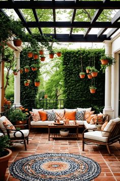 an outdoor living room with potted plants on the ceiling and seating area in front