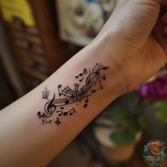 a hand with musical notes on it and a flower in the corner next to it