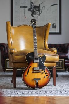 an electric guitar sitting on top of a chair