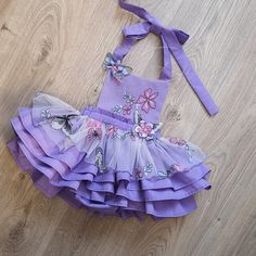 Lavender Tutu Dress For Summer Party, Summer Party Lavender Tutu Dress, Fitted Purple Tutu Dress For Spring, Spring Garden Party Bubble Romper With Ruffles, Cute Lavender Party Dress, Whimsical Ruffled Tutu Dress For Garden Parties, Purple Ruffled Dress For Birthday, Cute Purple Tutu Dress For First Birthday, Purple Cute Tutu Dress For First Birthday