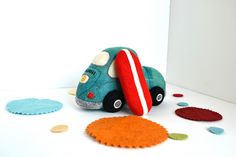 a blue toy car with a red surfboard on it's back and some circles around it