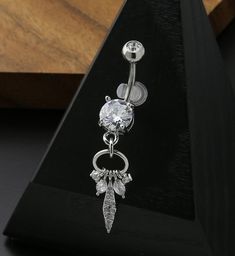 Sparkling belly button ring with a dangling, clear cz charm design with round, marquise, and oval shapes. Size is 14G with a 3/8" 10mm barbell. It is made from 316L stainless steel. Externally threaded. Top clear cz measures at about 5mm. Bottom clear cz gem is a 8mm. Bottom dangle design is about 30mm x 8mm. Sold individually (1 pc). Belly Button Rings Dangle, Sparkling Jewelry, Belly Button Ring, Sparkle Jewelry, Button Ring, Ring Collection, Belly Ring, Dangle Charms, Belly Rings