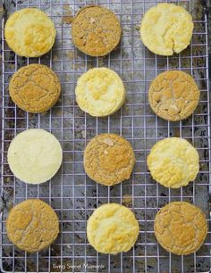 nine cookies cooling on a wire rack with yellow icing and brown sugar sprinkles