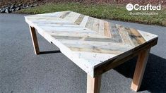 a wooden table sitting on top of a parking lot