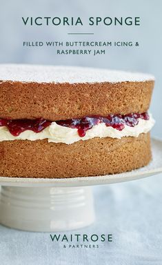 a cake on a plate with the words victoria sponge filled with buttercream icing and raspberry jam