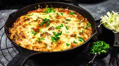 a casserole with meat and cheese in a skillet on a wire rack