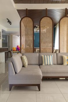 a living room filled with furniture and lots of windows