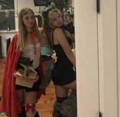 two women dressed in costumes standing next to each other