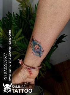 a woman's foot with a tattoo on it and a peacock feather in the middle