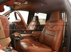 the interior of a vehicle with brown leather seats and wood trimmings on it