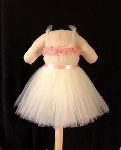 A handmade ivory dress made with tons of tulle to create maximum fullness and coverage.  Perfect for a wedding or any special event. The dress is made with a crocheted elastic band and has adjustable tie straps so it will stay in place.  The dress is finished with a flower petal trim, straps and sash. The dress can be made with white, ivory, pink or any other color tulle.  Depending on the desired color trim and sash can be changed as well. Please put child's measurements in the comment box.  I need width and length measurements.  Please measure around the child's chest width.  For length measure from inside the armpit to desired length.  Production does not begin until measurements are received! Every tutu, dress, and costume is made to order! We take pride in our products and sew or hand Formal Flower Girl, Custom Gift Wrapping, Ivory Dress, Ivory Dresses, Flower Petal, Flower Girl Dress, Tutu Dress, Girl Costumes, Flower Petals