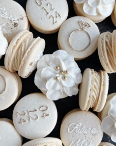 some cookies with wedding rings and flowers on them