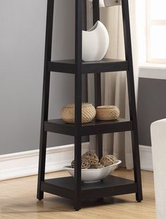 a wooden shelf with three bowls and two vases sitting on it's sides