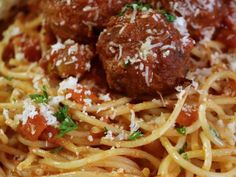 spaghetti with meatballs and parmesan cheese on top