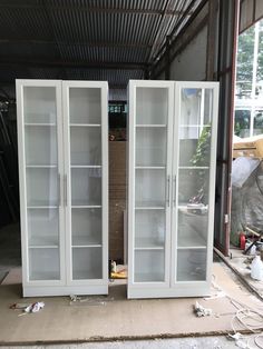 two white glass doors sitting inside of a building