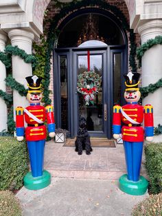 two large nutcrackers are standing in front of a door with wreath on it