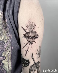 a woman with a tattoo on her arm holding a knife and heart in the middle