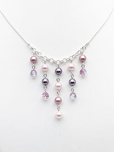 A pretty necklace placed under the sign of romanticism with its pretty soft shades of pink and purple gathered on Swarovski crystal beads. Its degraded size charms are composed of 925 silver rods of European manufacture, just like the rings from which they are suspended as well as the chain. You also have the option to buy the earrings individually... https://www.etsy.com/fr/listing/861625950/boucles-doreilles-pendantes-perles?ref=shop_home_active_38&frs=1 ... and the complete adornment on my sh Pink Pearl Dangle Necklaces, Elegant Pink Sterling Silver Crystal Necklace, Pink Sterling Silver Beaded Necklace, Pink Elegant Dangle Beaded Necklaces, Rose Violette, Pretty Necklace, Necklace Charms, Swarovski Crystal Beads, Pretty Necklaces