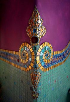 an artisticly designed bathroom with colorful tiles on the walls