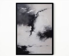 a black and white painting hanging on the wall