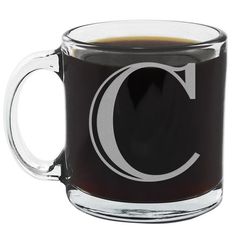 a glass coffee mug with the letter c on it