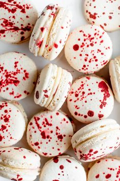 white macaroons with red sprinkles on them