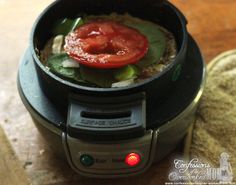 a close up of a food processor with tomatoes and spinach in it's center