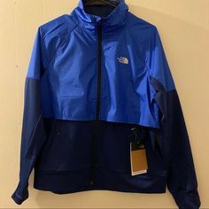 *100% AUTHENTIC* *BRAND NEW* *SOLD OUT IN STORES* Brand: The North Face Color: TNF Blue/Flag Blue Condition: New with Tags RETAIL PRICE $120.00 Measurements Armpit to Armpit 22" Waist 21" Hips 22" Hem Width 22" Length from Shoulder to Hem 25.5" Features - Standard Fit - Stretch Knit Fabric - Brushed Fleece Lining - Stretch Cuffs with Thumb Hole - Collared - DWR Durable Water Repellent Finish - Lightweight - Front Zipper Closure with Interior Draft Flap - 2 Exterior Zip Pockets - 2 Interior Slip Blue Windproof Outerwear For Fall, Fitted Functional Blue Outerwear, Fitted Blue Windbreaker For Winter, Fitted Blue Winter Windbreaker, Blue Fall Track Jacket For Outdoor, Blue Sporty Outerwear For Work, Blue Sport Coat For Fall, Blue Sport Coat For Fall Sports, Blue Functional Outerwear For Work