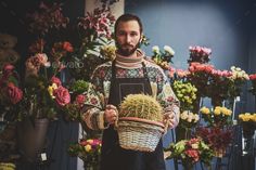 a man holding a basket full of flowers