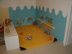 a child's play room with toys on the floor and in the wall,