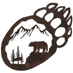 the bear is standing on top of the mountain with trees in it's mouth