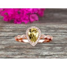 an engagement ring with a pear shaped yellow diamond in the center