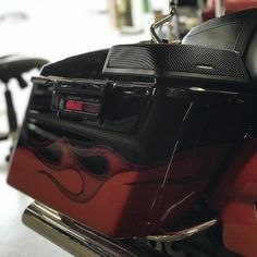 the back end of a red and black motorcycle with flames painted on it's side