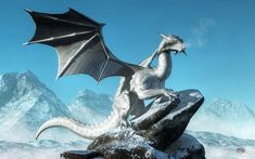 a white dragon sitting on top of a rock in front of snow covered mountain tops