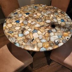 a table that has some kind of rock on it in the middle of two chairs