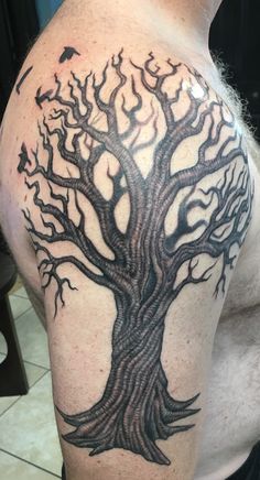 a man with a tree tattoo on his arm