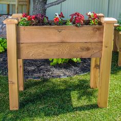 two wooden planters with flowers in them