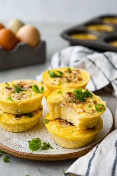 mini egg muffins on a plate with eggs in the background