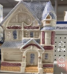 a toy house is on display for sale at a store with the price tag below it