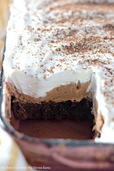 there is a cake with white frosting in the pie pan on the wooden table