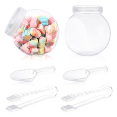 there are many different types of candy in the glass jar and spoons next to each other