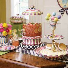 there are many cakes and desserts on the table with checkered placemats