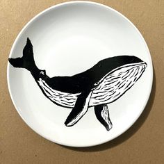 a plate with a drawing of a whale on it