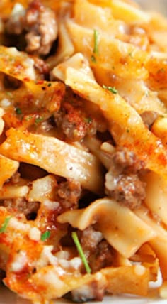 pasta with meat and cheese on a white plate