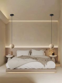 a large bed sitting in the middle of a room with two lamps hanging above it